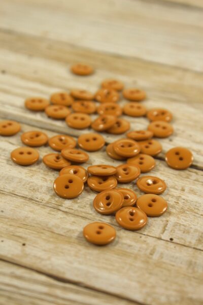 Boutons essentiel en plastique jaune curry Eglantine et Zoé à coudre sur des chemises, blouses et robes